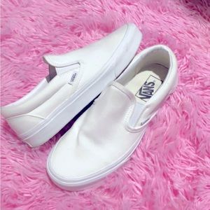 All white Vans slides.